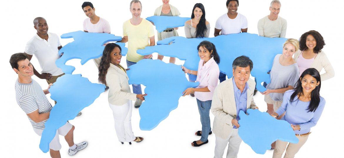 Multiethnic-group-of-casual-people-holding-abstract-world-map-000021292734_Large-1